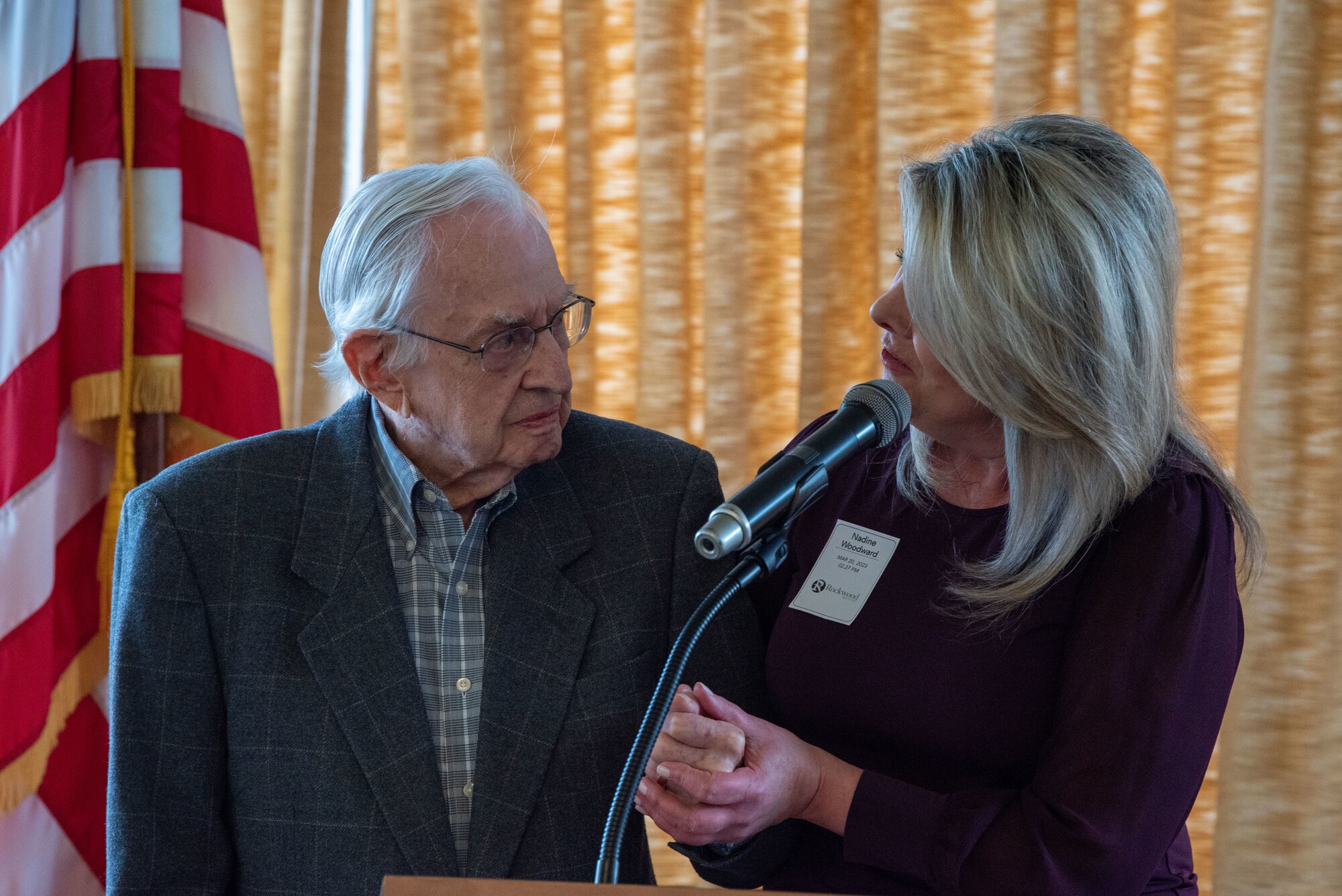 Mayor Nadine Woodward (right) commends retired U.S. Air Force Maj. Stan Bennet (left), a WWII veteran, for his military service at Rockwood Retirement South Hill March 20, 2023. Bennet was assigned to the B-24 bombers as a navigator and flew multiple combat missions. (U.S. Air Force photo by Airman 1st Class Lillian Patterson)