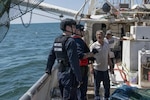 Coast Guard Cutter Daniel Tarr law enforcement crew members conduct a fisheries boarding aboard a shrimping vessel off the coast of Louisiana, on April 24, 2022. Fishery boardings are conducted to ensure commercial fisheries are following federal laws and regulations on the water. (U.S. Coast Guard Photo by Petty Officer 3rd Class Alejandro Rivera)