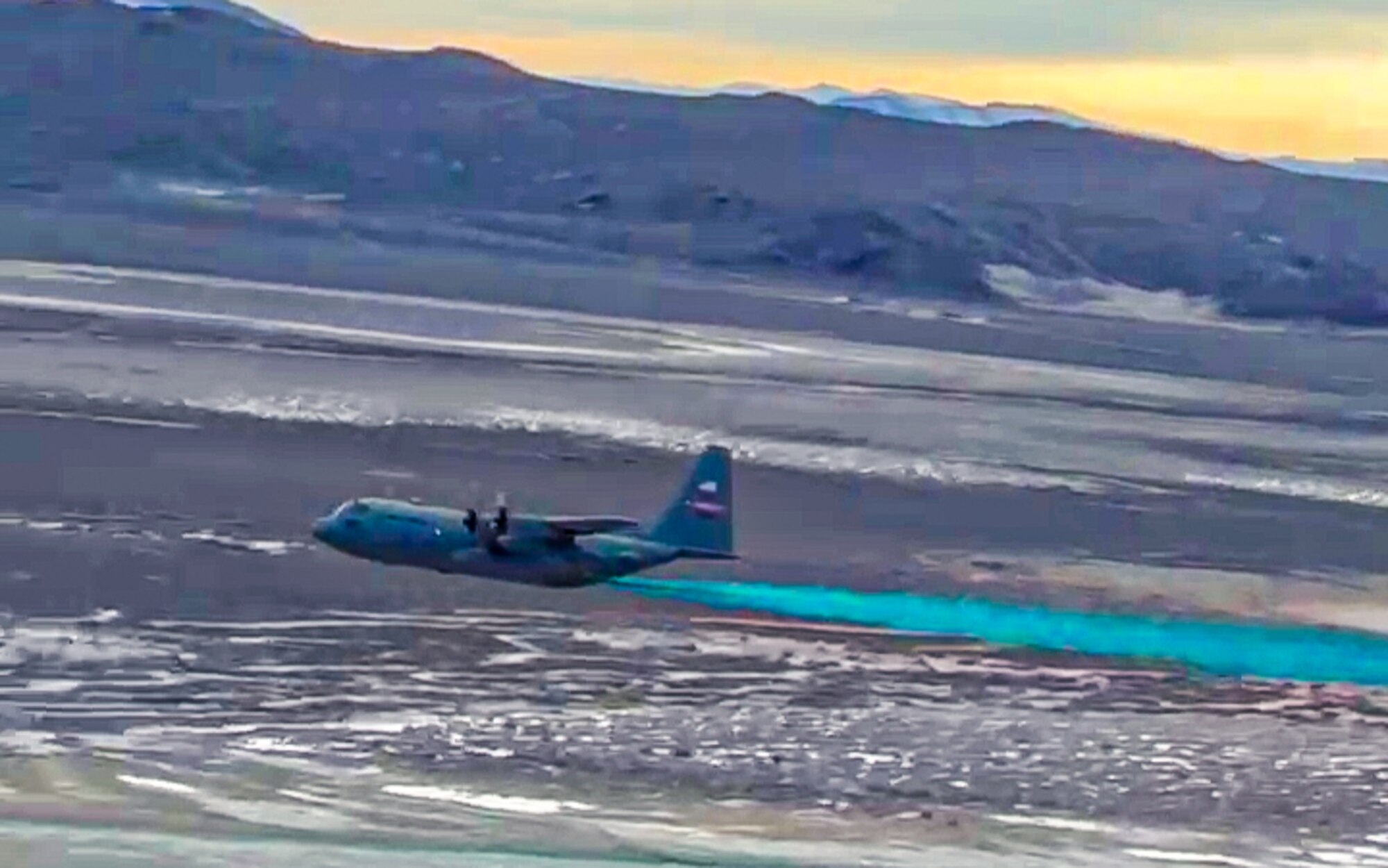 An aerial spray-modified C-130H Hercules aircraft assigned to the 910th Airlift Wing, Youngstown Air Reserve Station, Ohio, conducts the first product spray out of the unit’s new electronic modular aerial spray system, on March 9, 2023, over the Utah Test and Training Range near Hill Air Force Base.