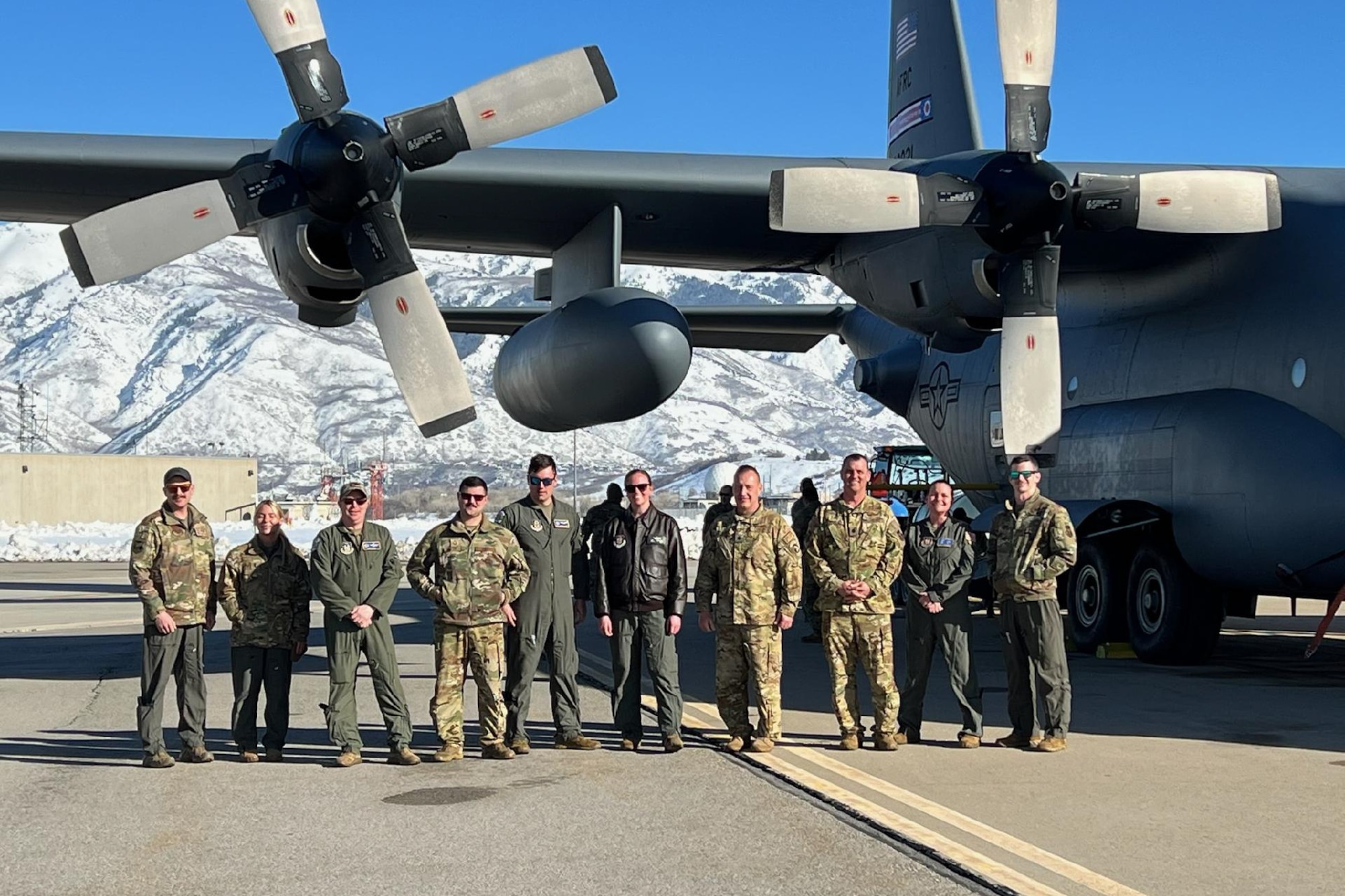 The aircrew members pose in front of an aerial spray-modified C-130H Hercules aircraft assigned to the 910th Airlift Wing, Youngstown Air Reserve Station, Ohio, after the new electronic modular aerial spray system’s first product spray, on March 9, 2023, over the Utah Test and Training Range near Hill Air Force Base.