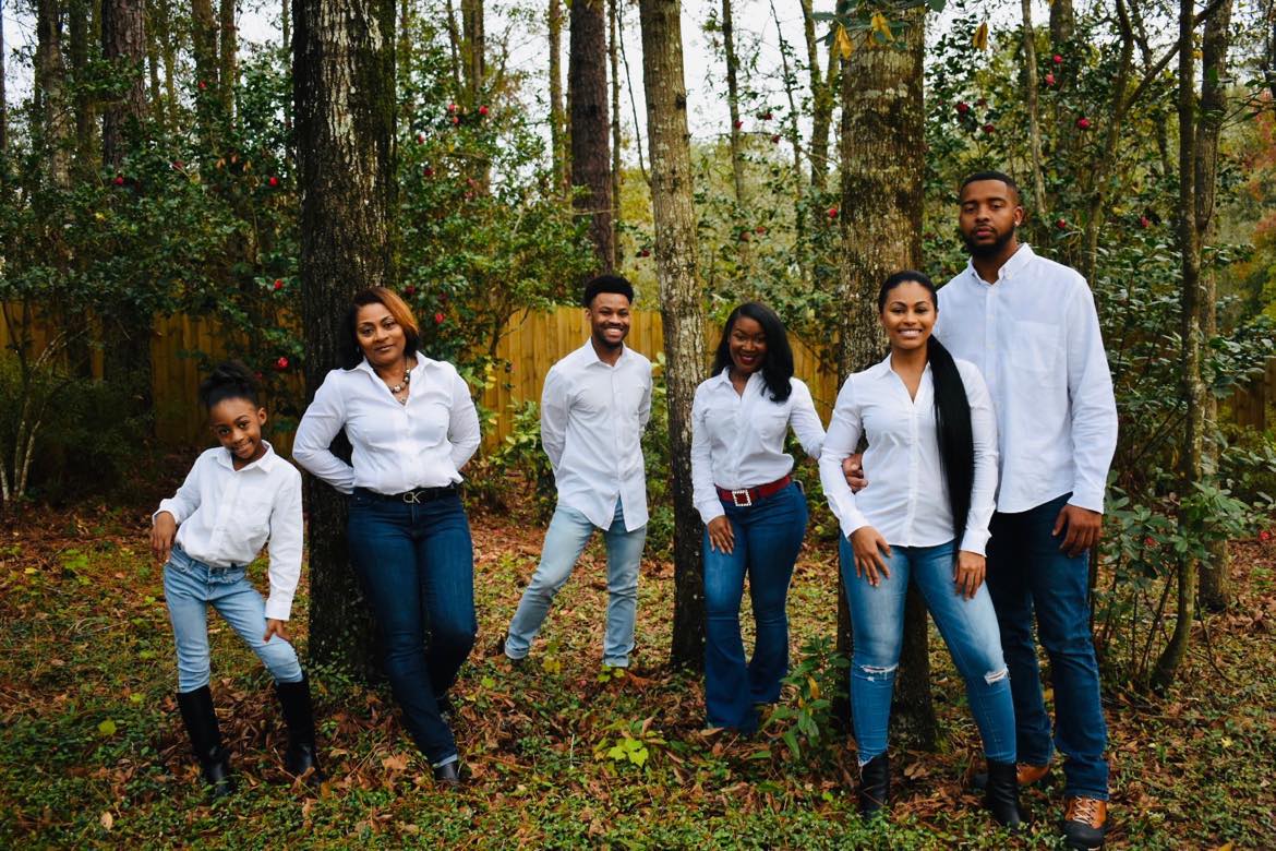 Sonya Rodgers, Chief of the Office of Small Business Programs, left in front of the tree,