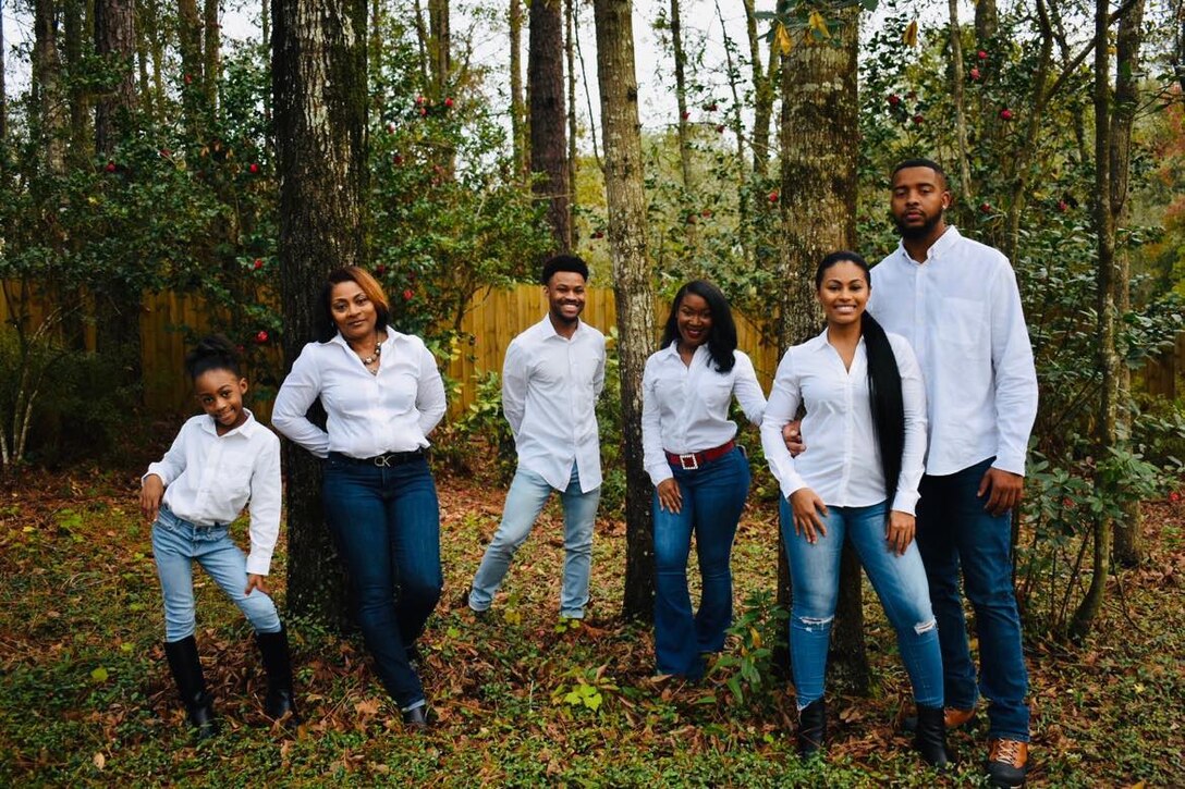 Sonya Rodgers, Chief of the Office of Small Business Programs, left in front of the tree, poses for a family portrait with her kids and grandkids, March 19, 2023, Mobile, Alabama. Rodgers said her faith and family have been the inspirations for her success. (U.S. Army photo by Chuck Walker)