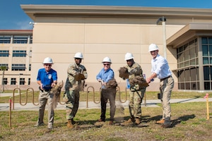 As ground is broken for a new memorial at the Air Force Technical Applications Center at Patrick Space Force Base, leaders symbolically toss shoveled earth where the memorial will be erected to honor fallen Airmen and civilians who once worked at the nuclear treaty monitoring center.  Pictured are:  Lou Seiler, AFTAC Memorial Corp.; Col James A. Finlayson, AFTAC commander; Todd Pokrywa, The Viera Company president; Col. Anthony Graham, SLD 45 vice commander; and Nick Crowe, Viera Builders executive vice president.  (U.S. Air Force photo by Matthew S. Jurgens)