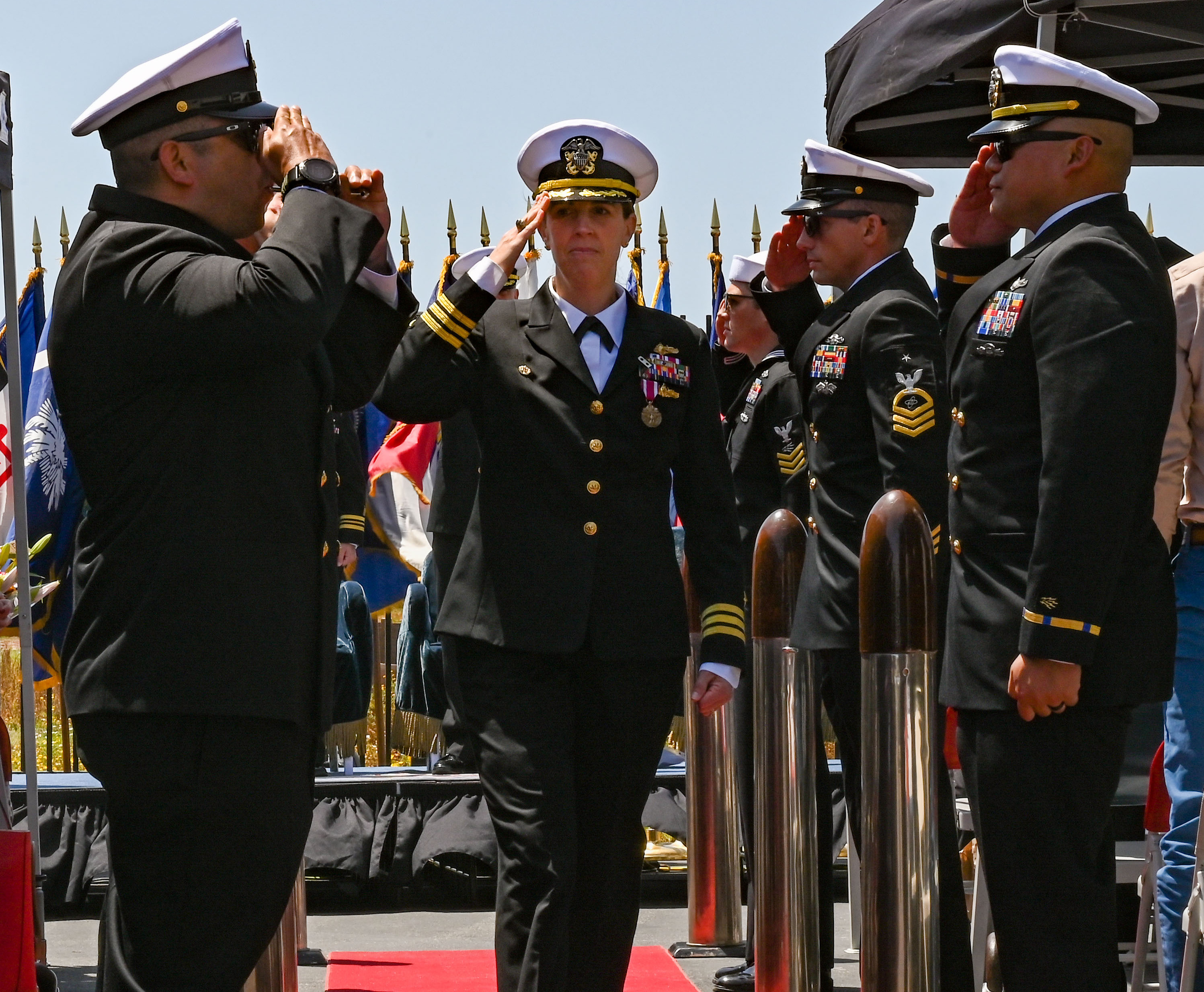 Cmdr. Blythe Blakistone salutes during a change of command ceremony for Naval Special Warfare Tactical Communications Command (TCC) 1