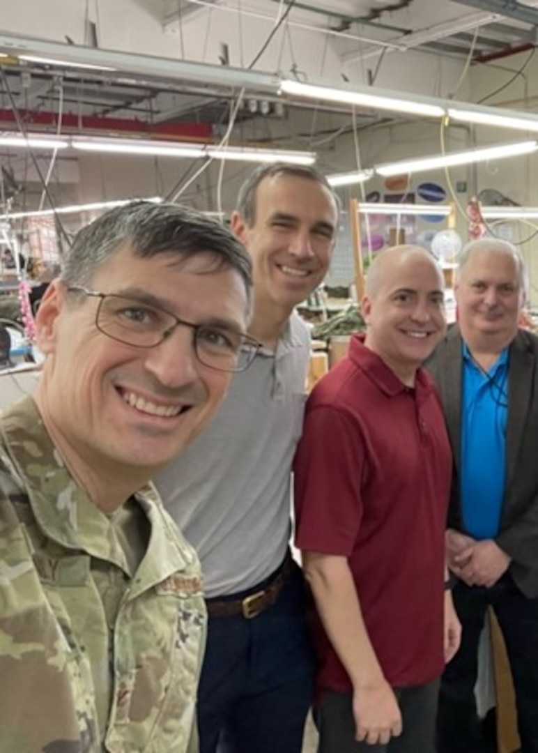 four men smile in selfie