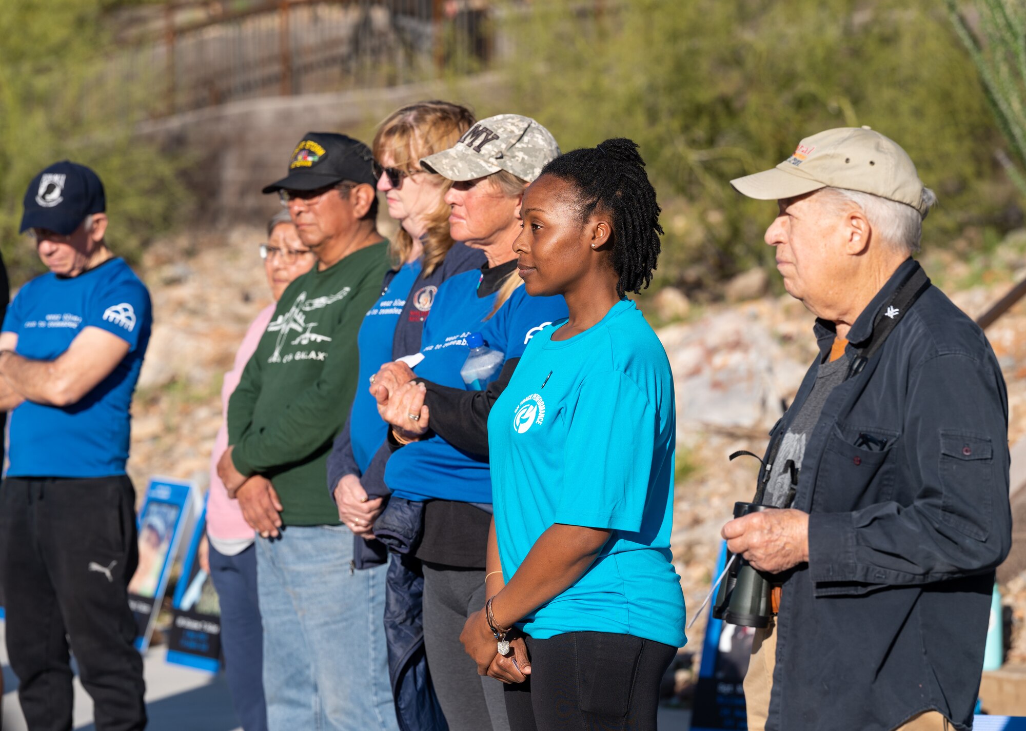 Participants of the Wear Blue: Run to Remember Piestewa Challenge listen to guest speakers March 26, 2023, at Piestewa Peak trailhead in Phoenix, Arizona.