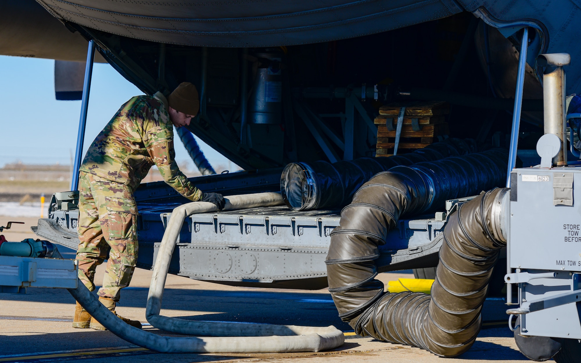 Tech. Sgt. Patrick Sherman, an aerial spray system maintainer assigned to the 910th Maintenance Squadron, loads water into an aerial spray modified C-130H Hercules aircraft assigned to the 910th Airlift Wing, Youngstown Air Reserve Station, Ohio, on March 14, 2023, at Hill Air Force Base, Utah.