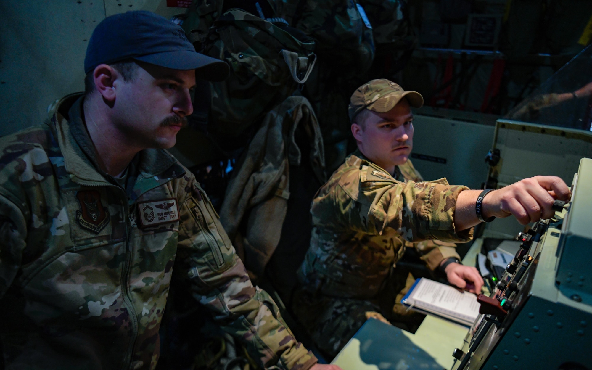 Senior Master Sgt. Rob Mitchell and Senior Airman Eric Martin, aerial spray qualified loadmasters assigned to the 757th Airlift Squadron, run preflight checks on a modular aerial spray system aboard an aerial spray modified C-130H Hercules aircraft assigned to the 910th Airlift Wing, Youngstown Air Reserve Station, Ohio, on March 14, 2023, at Hill Air Force Base, Utah.