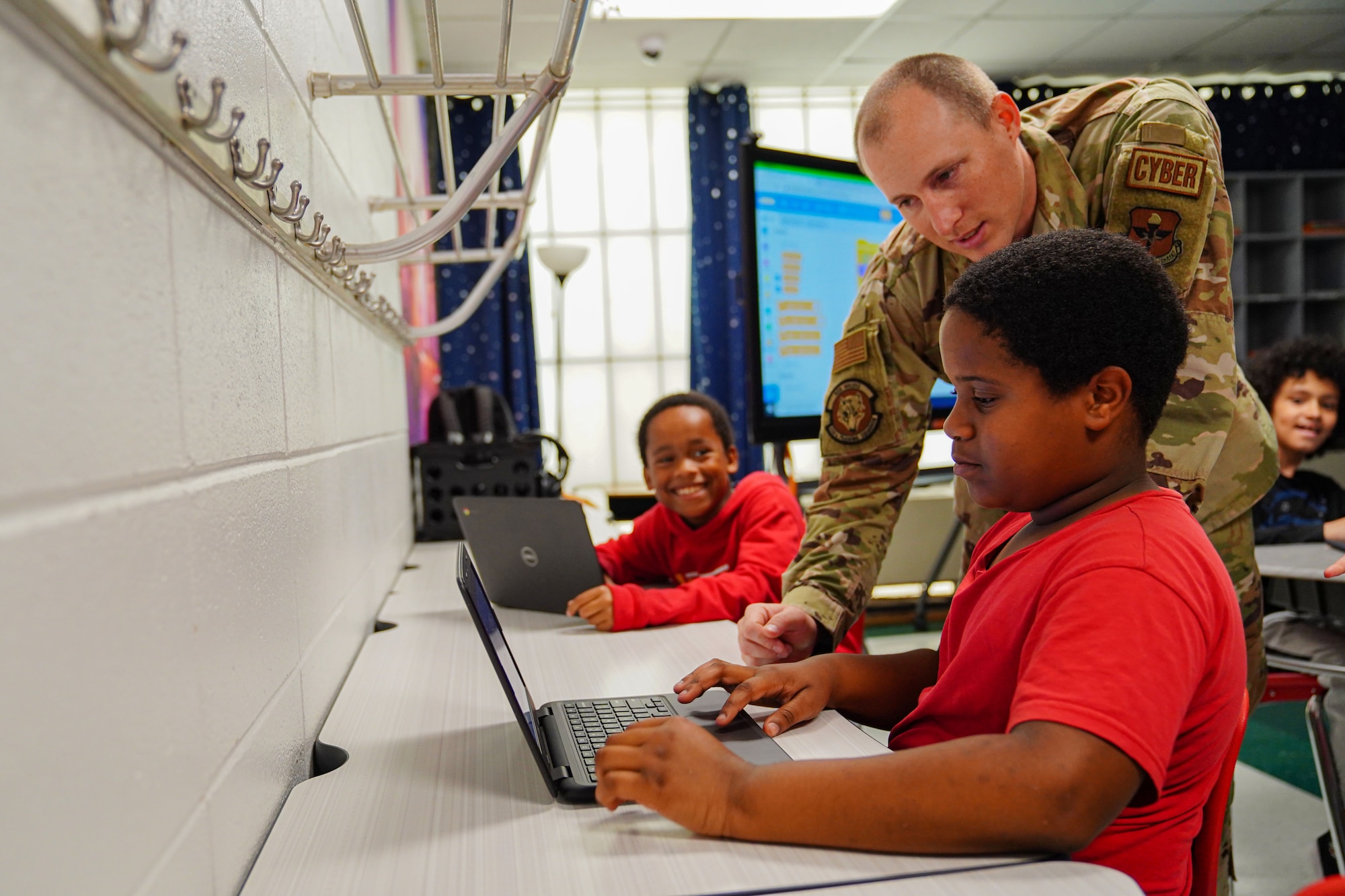 U.S. Air Force Tech Sgt. Shane Balkcom, 336th Training Squadron learning program manager, shows a student how to create basic algorithm blocks at Back Bay Elementary School on March 23, 2023. The 336th TRS collaborated with Back Bay Elementary to teach 4th grade students the basics of programing through a seven week course.