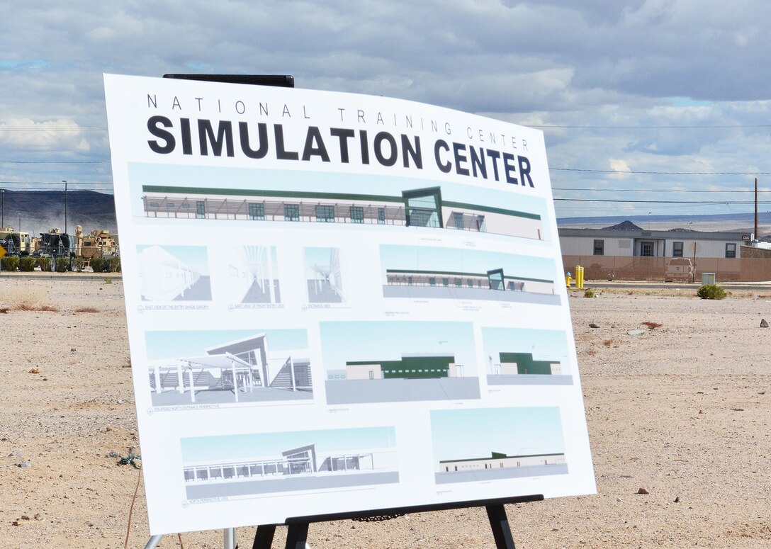 A rendition of the new Simulations Center is displayed during a groundbreaking ceremony for the facility March 23 at Fort Irwin, California.