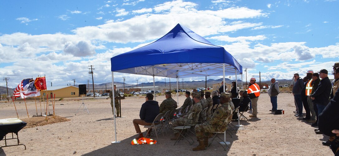 An audience of senior leaders, Soldiers, project managers and contractors from the U.S. Army Corps of Engineers Los Angeles District, Fort Irwin and the Corps’ contractor, RA Burch, listen to remarks from Brig. Gen. Curtis Taylor, commanding general of the National Training Center and Fort Irwin, during a March 23 groundbreaking ceremony for a new Simulations Center at Fort Irwin, California.