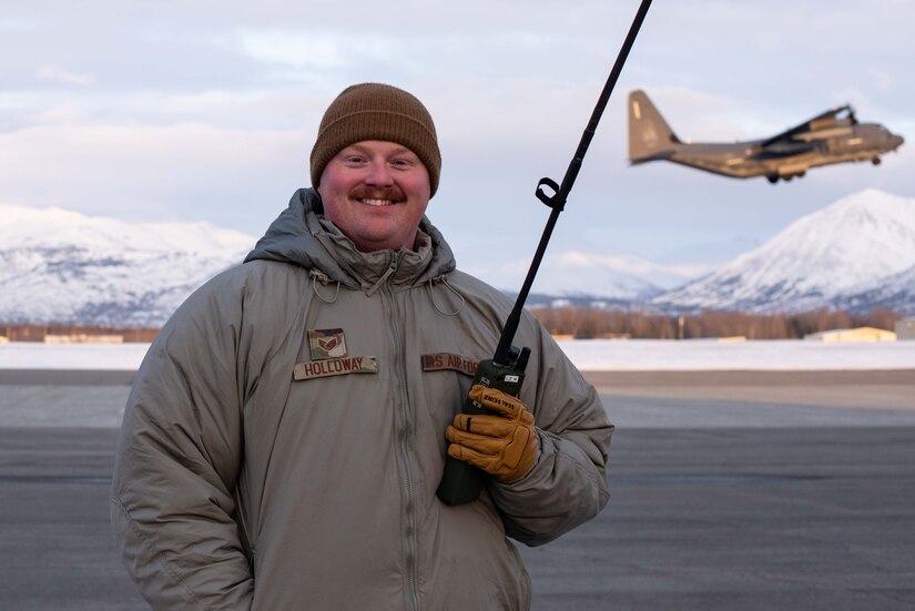 Photo of an air traffic controller and a C-130