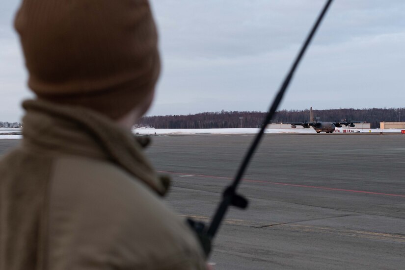 Photo of an air traffic controller and a C-130