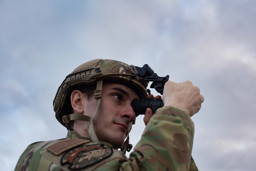 Photo of an airfield management Airman using night vision goggles