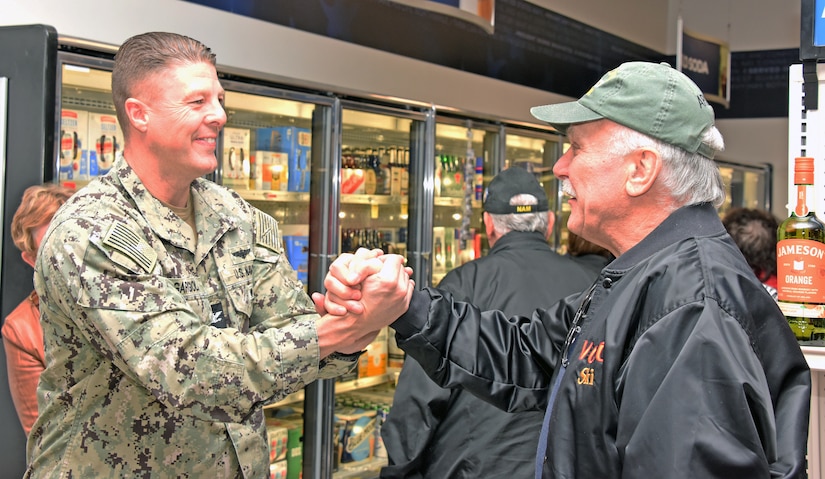 U.S. Navy Capt. Frank Ingargiola, Joint Base McGuire-Dix-Lakehurst deputy commander and Naval Support Activity commander, greets a veteran at a Vietnam veterans recognition ceremony at Joint Base McGuire-Dix-Lakehurst, N.J., Mar. 29, 2023. The purpose of this ceremony was to honor and thank the veterans who served their country with courage and selflessness during the Vietnam War, as part of the nationwide effort to recognize their contributions and sacrifices. Since 2018, the Navy Exchange located on Joint Base MDL has been holding this annual ceremony, which has become an important tradition to express appreciation and respect for the brave men and women who risked their lives for the nation. (U.S. Air Force photo by Daniel Barney)