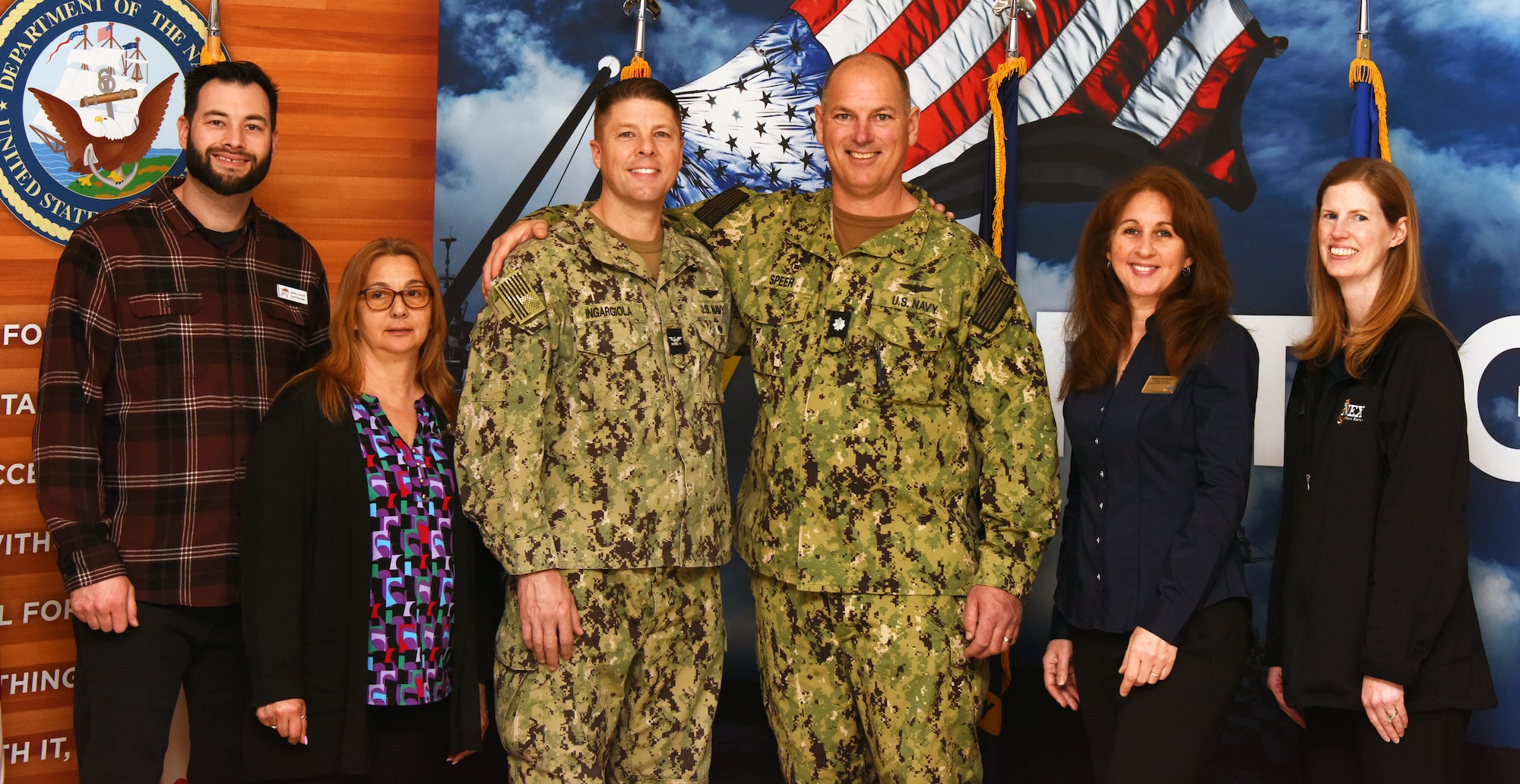 U.S. Navy Capt. Frank Ingargiola, Joint Base McGuire-Dix-Lakehurst deputy commander and Naval Support Activity commander, and U.S. Navy Cmdr. Craig Speer, NSA Lakehurst executive officer, pose for a group photo with the NEX Exchange and Commissary staff at a Vietnam veterans recognition ceremony at Joint Base McGuire-Dix-Lakehurst, N.J., Mar. 29, 2023. The purpose of this ceremony was to honor and thank the veterans who served their country with courage and selflessness during the Vietnam War, as part of the nationwide effort to recognize their contributions and sacrifices. Since 2018, the Navy Exchange located on Joint Base MDL has been holding this annual ceremony, which has become an important tradition to express appreciation and respect for the brave men and women who risked their lives for the nation.