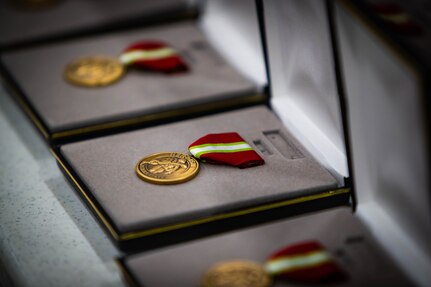 Alaska Heroism Medals sit ready March 28, 2023, for the ceremony at the John Apangalook Memorial High School gymnasium honoring 16 Alaska Army National Guard First Scouts for their heroism during a 1955 rescue mission after two Russian MiG-15s shot down a U.S. Navy P2V-5 Neptune plane flying a routine maritime patrol over the Bering Sea with 11 sailors on board.