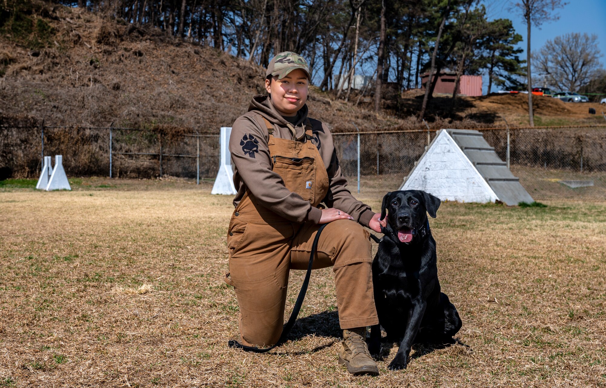 U.S. Air Force Senior Airman Michayla Coleman, 51st Security Forces Squadron, military working dog (MWD) handler poses for a photo with her partner Beatle in celebration of Women’s History Month at Osan Air Base, Republic of Korea, March 27, 2023.