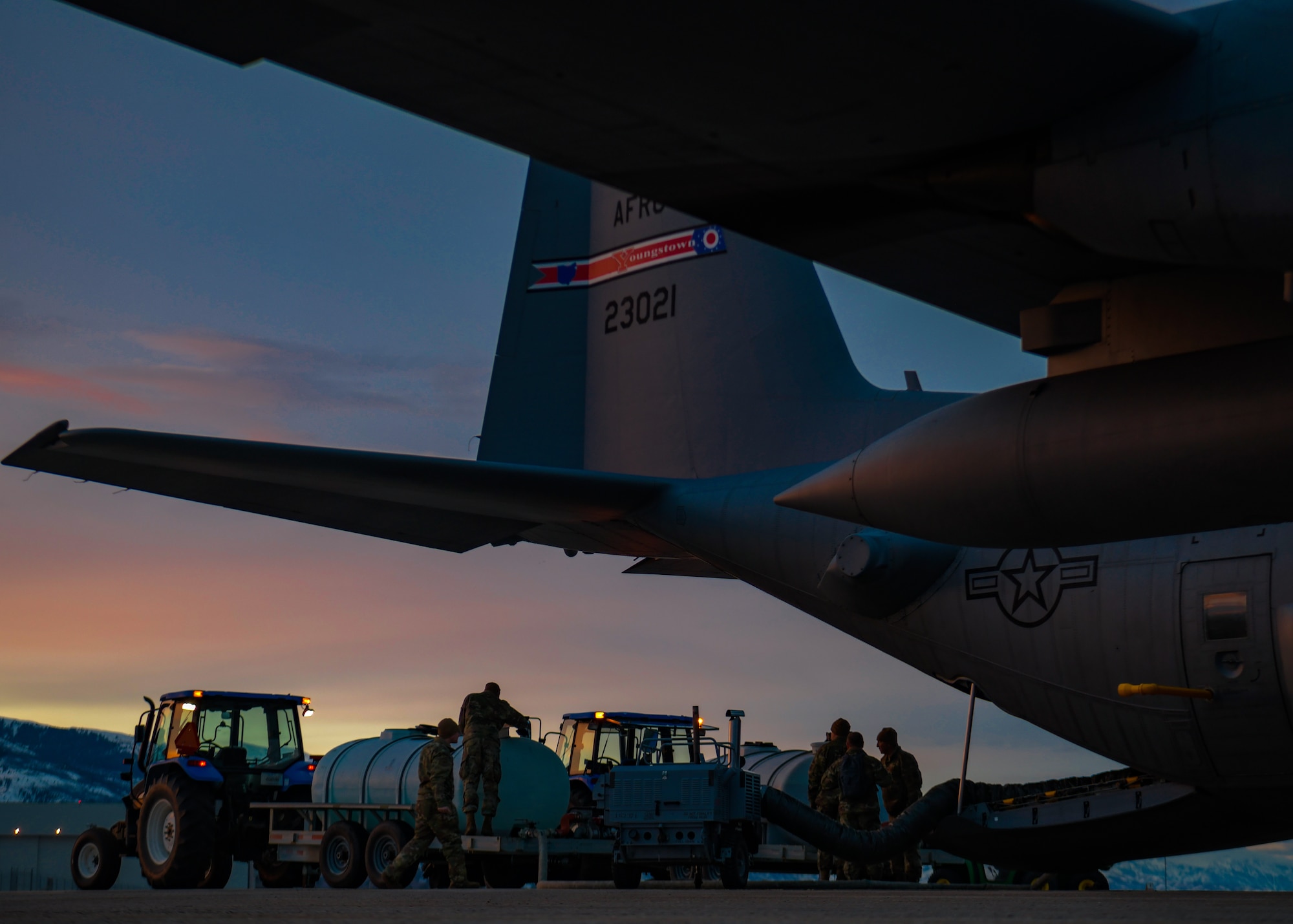 Aerial spray system maintainers assigned to the 910th Maintenance Squadron load product into an aerial spray-modified C-130H Hercules aircraft assigned to the 910th Airlift Wing, Youngstown Air Reserve Station, Ohio, on March 14, 2023, at Hill Air Force Base, Utah.