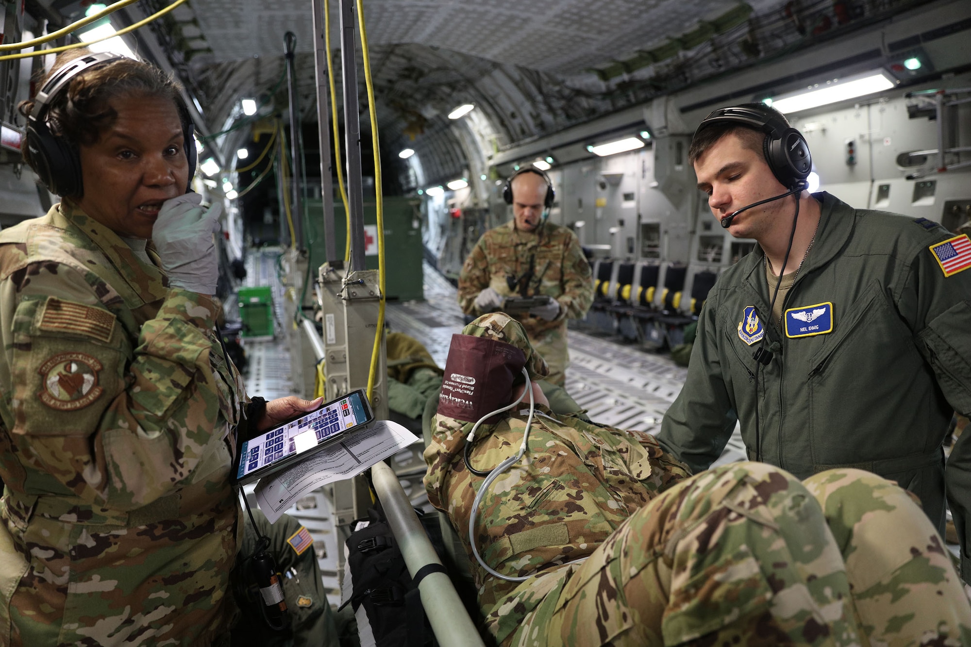Lt. Col. Jenice Brown and Capt. Neil Ehmig, both flight nurses with the 445th Aeromedical Evacuation Squadron, check the vitals on a mock patient onboard a 445th Airlift Wing C-17 Globemaster III March 21, 2023. The training took place while they were enroute to Keesler Air Force Base, Mississippi with a follow on to St. Croix, U.S. Virgin Islands. The two were among six reservists from the 445th AES that participated in Dissimilar Aircraft Refresher Training (DART) at St. Croix March 21 – 23, 2023.