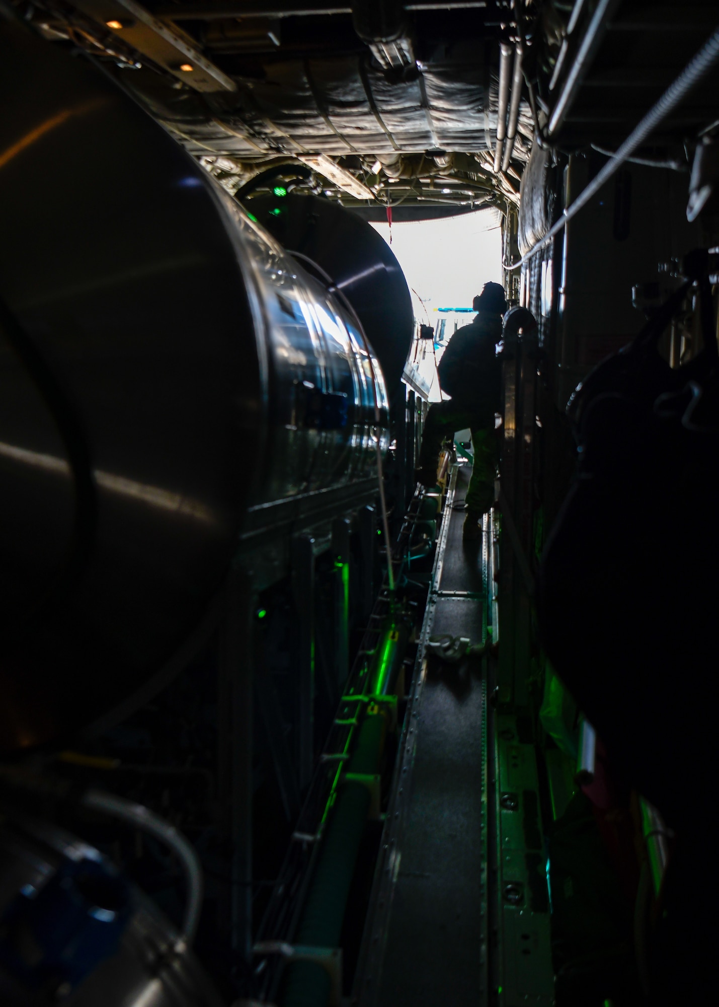 Staff Sgt. Zachery Wilson, an aerial spray system maintainer assigned to the 910th Maintenance Squadron, monitors the product loading of an electronic modular aerial spray system aboard an aerial spray modified C-130H Hercules aircraft assigned to the 910th Airlift Wing, Youngstown Air Reserve Station, Ohio, on March 14, 2023, at Hill Air Force Base, Utah.