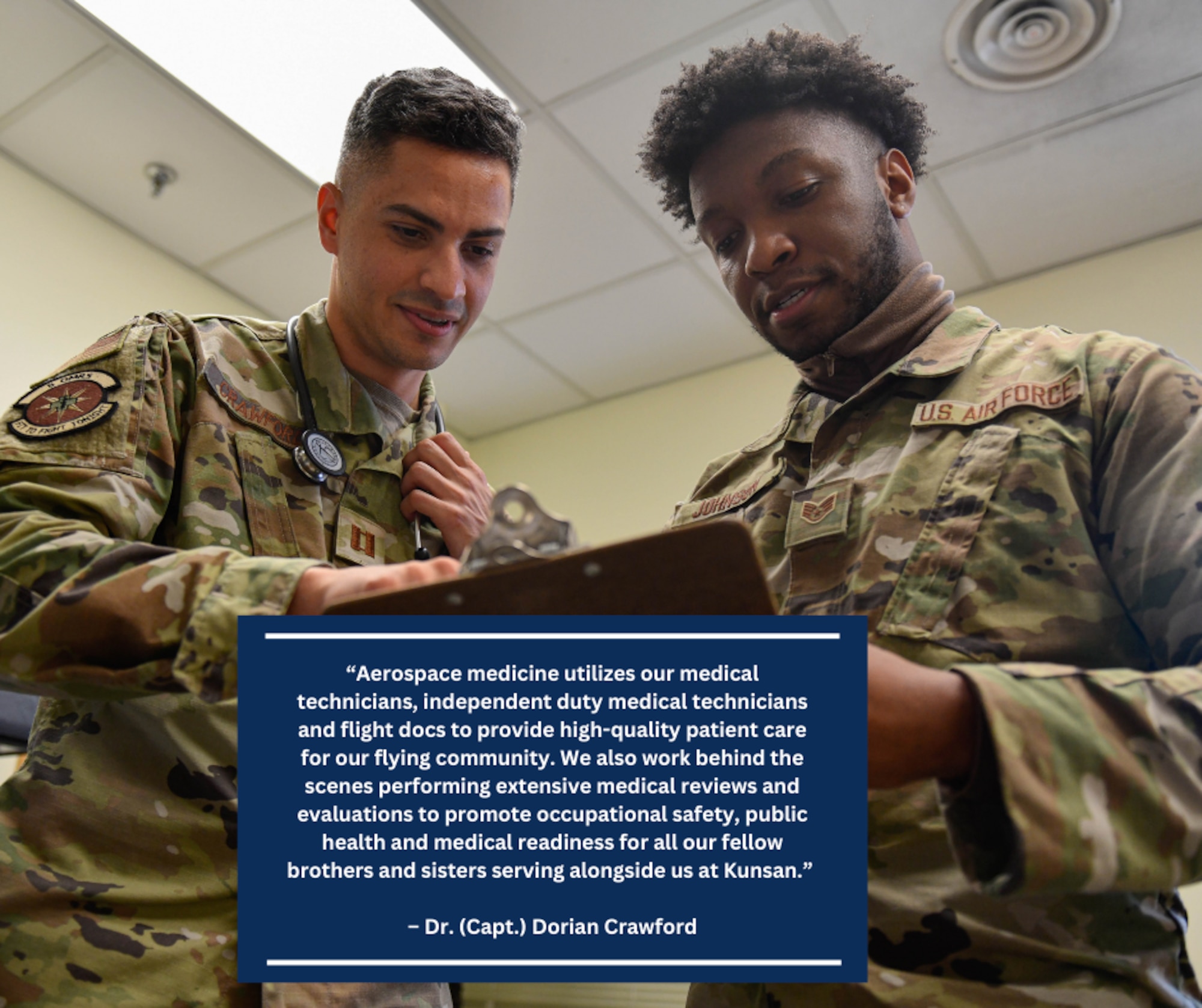 Two men discuss documents on a clipboard