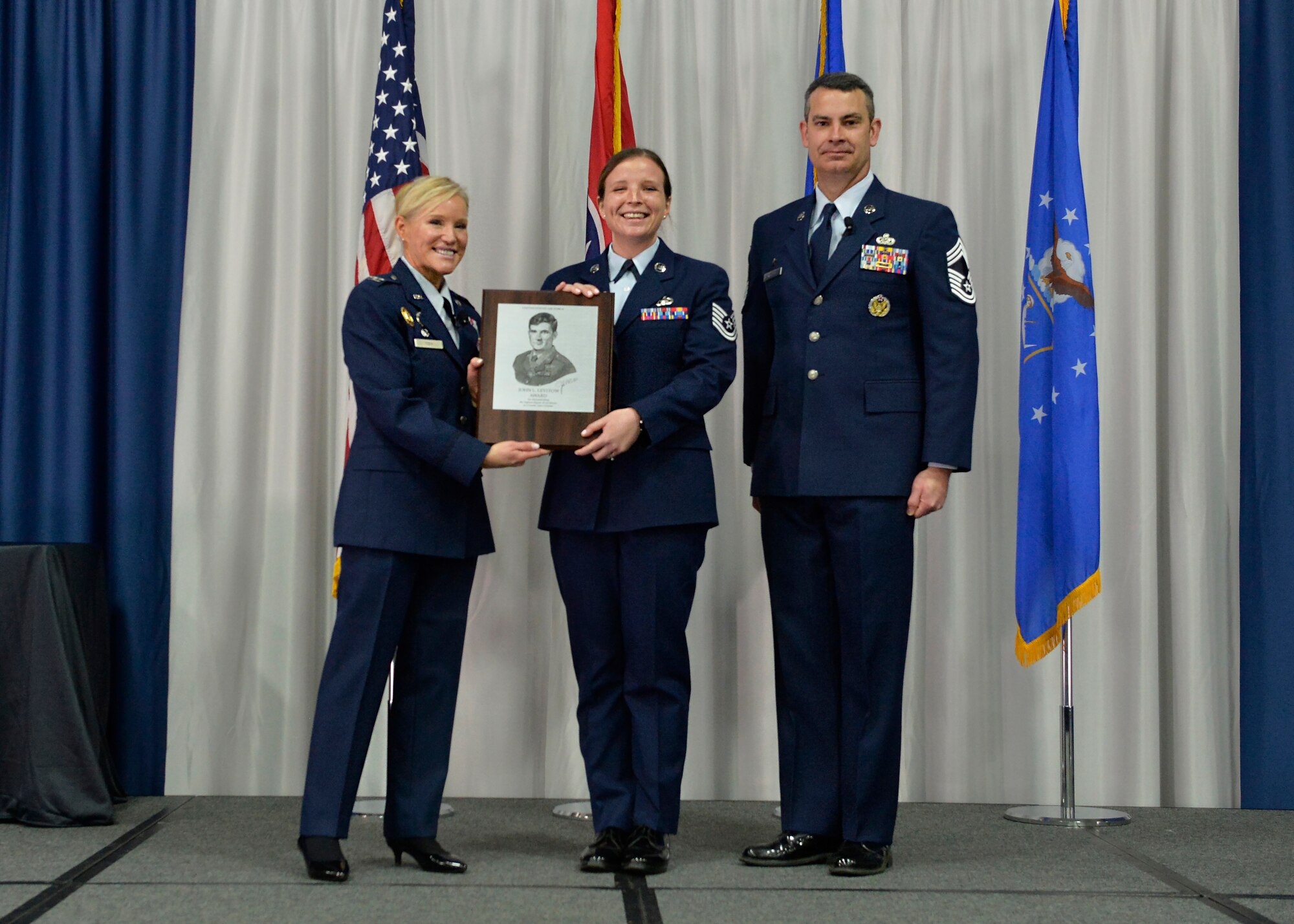 Airman receives an award during graduation.