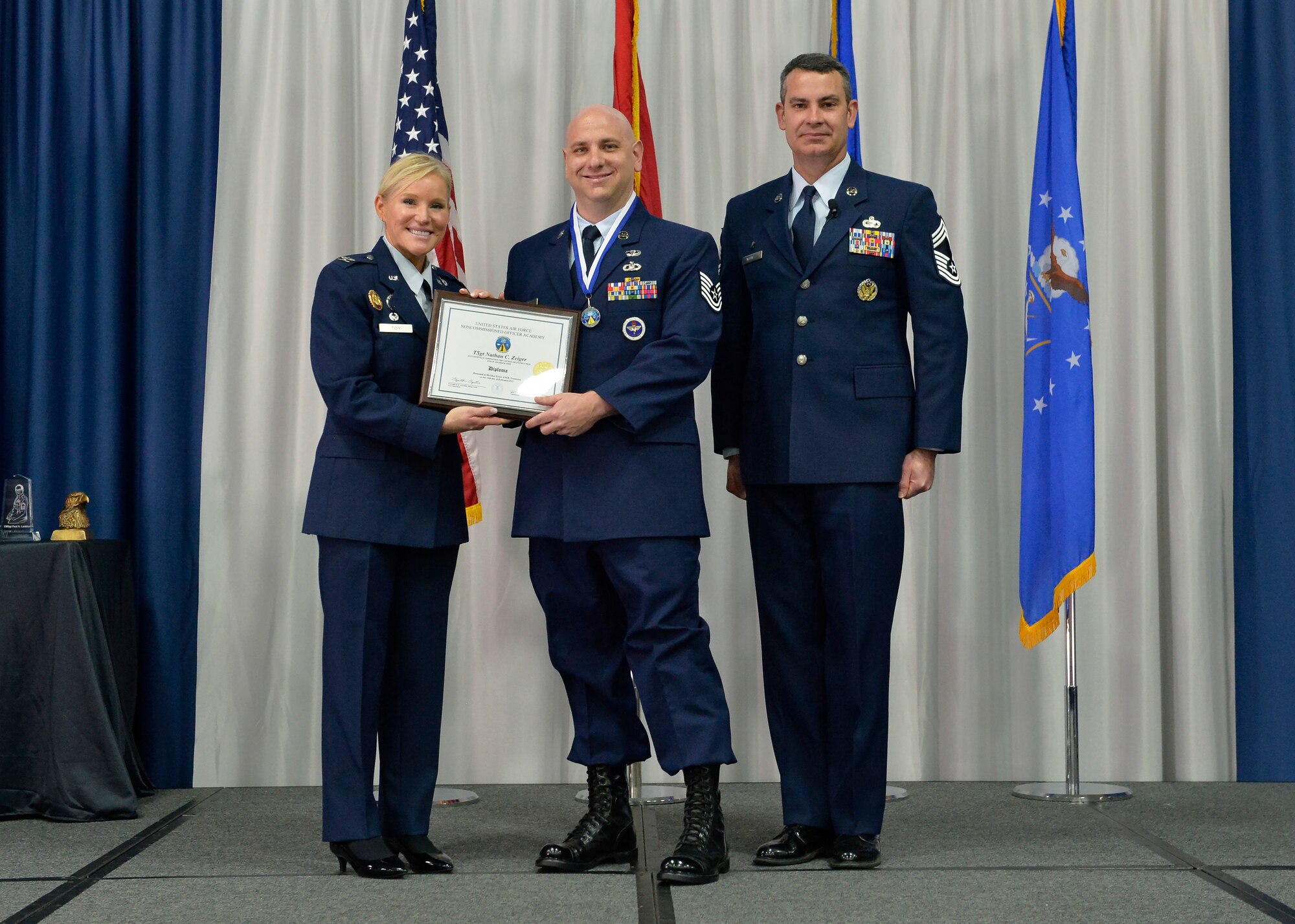 Airman receives an award during graduation.