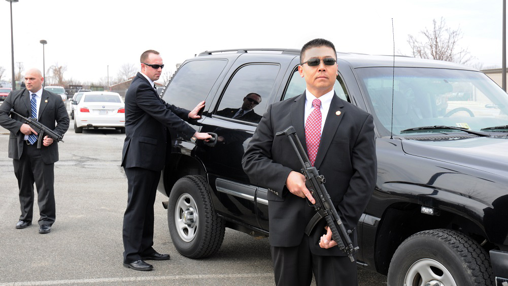 Protective services guard the vehicle of a high profile person