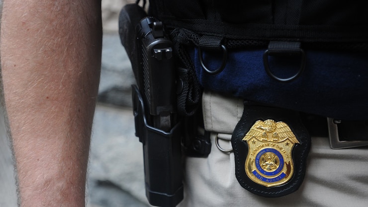 Army CID Agent with sidearm and Special Agent badge