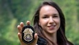 Female Army CID agent shows her special agent badge