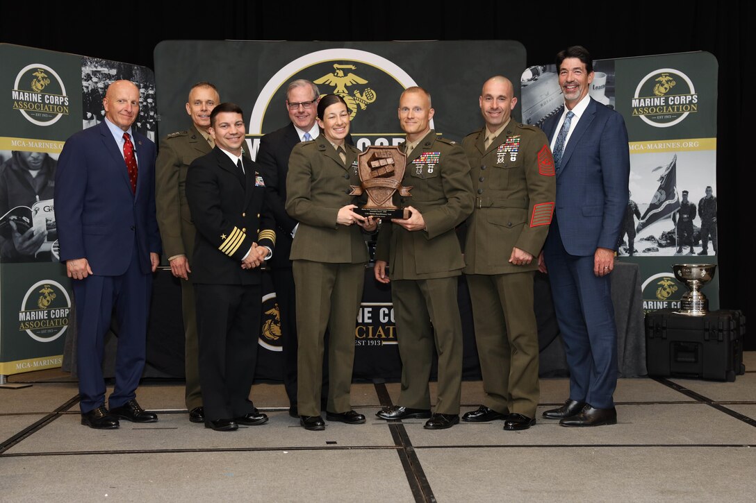 U.S. Marines with 11th Marine Expeditionary Unit, I Marine Expeditionary Force (I MEF) accept the Marine Corps Information Environment Enterprise Innovation Award in Arlington, Virginia, April 14, 2022. The third annual Marine Corps Association Information Awards Dinner, administered by the Deputy Commandant for Information, recognized 16 individual awards and 3 unit awards chosen from information communities including Intelligence, Command, Control, Communications and Computers (C4), Cyber, Psychological Operations (PSYOP), Space, Electromagnetic Spectrum Operations, Communication Strategy and Operations (COMMSTRAT) and Civil Affairs (CA). (U.S. Marine Corps photo by Lance Cpl. Christine Phelps)
