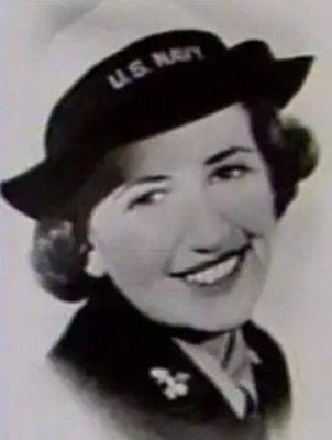 Black and white vintage photo of smiling woman in uniform