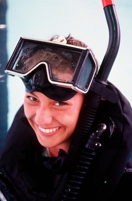 Smiling woman with rescue swimmer gear on