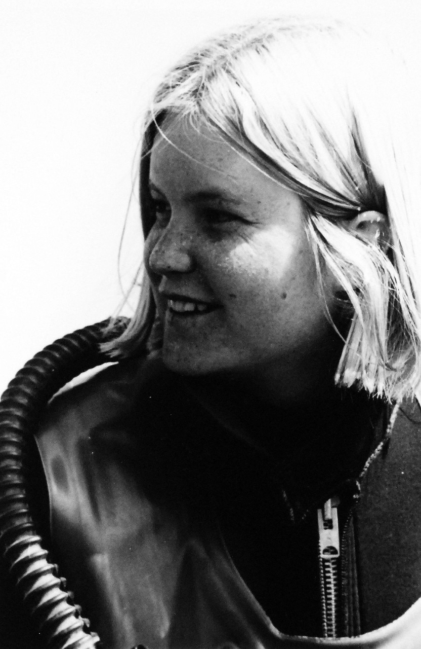Black and white photo of smiling woman looking left