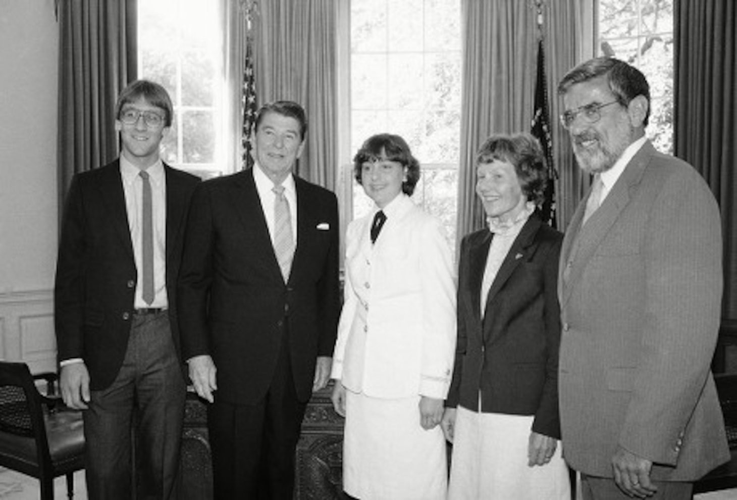 Black and white photo of President Reagan posing with Kristine Holderied at white house