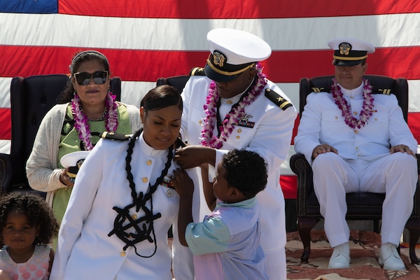 Bernadette McCray in white uniform being presented award