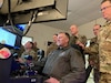 Lithuanian Air Force Col. Antanas Matutis, center, Lithuanian Air Force Commander, sits in a declassified U.S. Air Force MQ-9 Reaper simulator during a visit to Biddle Air National Guard Base in Horsham, Pennsylvania, Mar. 20, 2023. The 111th Attack Wing hosted Matutis, and his senior enlisted leader, Command Sgt. Maj. Alvydas Tamošiūnas, as part of a broader National Guard State Partnership Program (NG SPP) tour hosted by the Commander of the PAANG, Brig. Gen. Michael Regan. Pennsylvania and Lithuania have been partners under this program since April 27, 1993. (U.S. Air National Guard photo by Staff Sgt. Wilfredo Acosta)