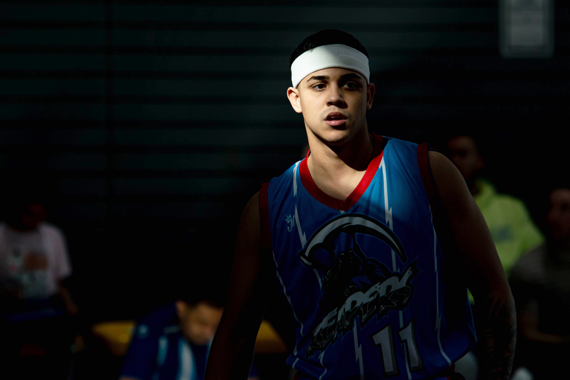 Basketball player waits for ball during basketball game.
