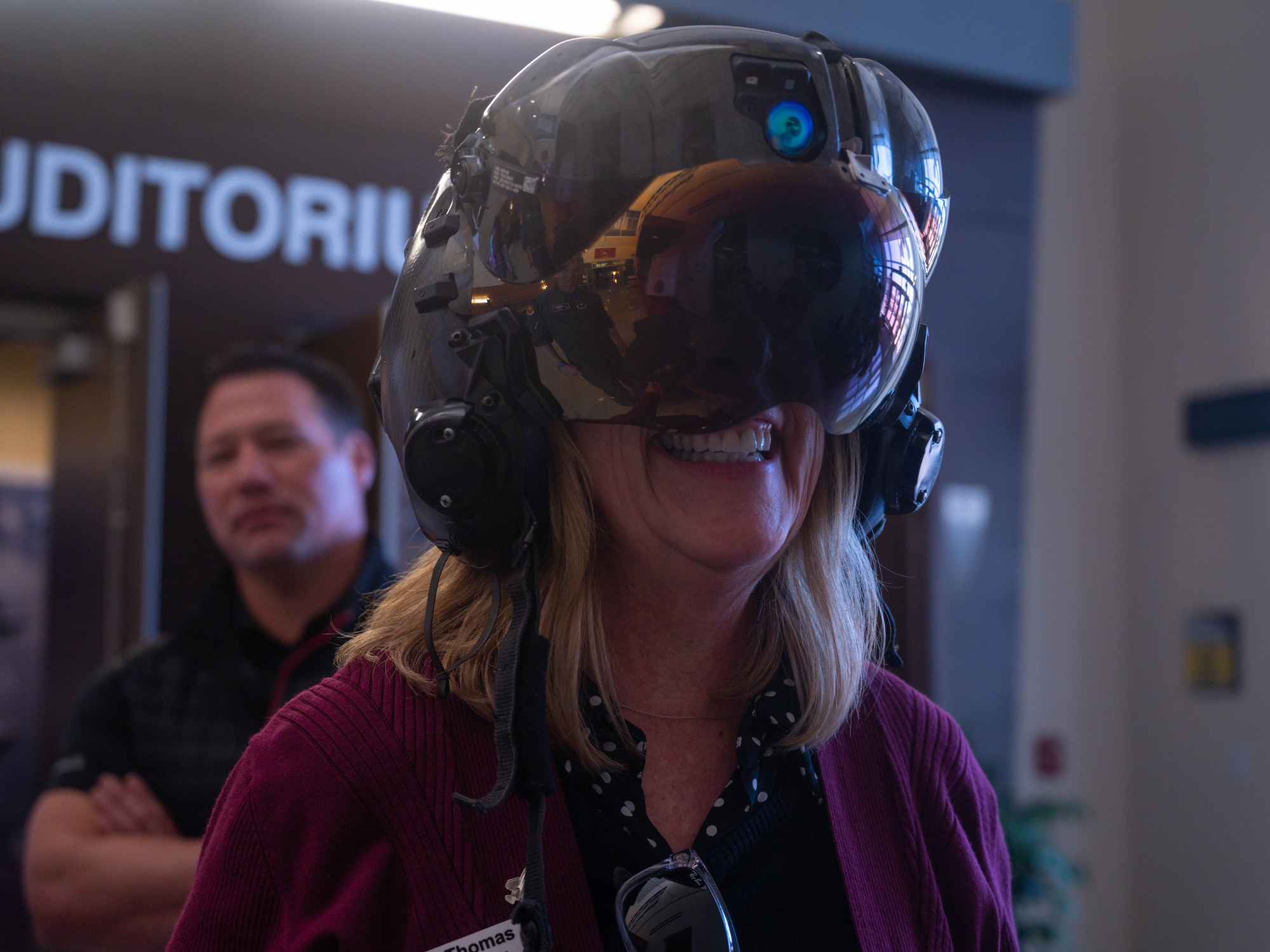 Jennie Thomas, 56th Fighter Wing command chief honorary commander, tries on a decommissioned F-35 Lightning II helmet March, 24, 2023, at Luke Air Force Base, Arizona.