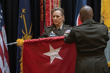 Command Sgt. Maj. Kenneth F. Law, U.S. Army Financial Management Command senior enlisted advisor, right, helps Brig. Gen. Paige M. Jennings, USAFMCOM commanding general, unveil her one-star flag during Jennings’ promotion ceremony at the Indiana Statehouse in Indianapolis Feb. 17, 2023. Jennings, a native of Missoula, Montana, began her military career in 1995 after commissioning into the Finance Corps as a distinguished military graduate of the University of Montana’s Grizzly Battalion Army Reserve Officer Training Corps program. (U.S. Army photo by Mark R. W. Orders-Woempner)
