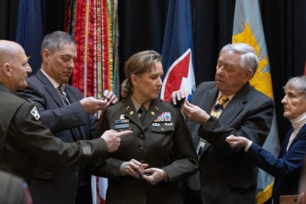 From left to right, Gen. Edward M. Daly, U.S. Army Materiel Command commanding general; Larry Jennings, husband; Alan Stohle, father; and Natalie Stohle, mother, pin one-star rank on Brig. Gen. Paige M. Jennings, U.S. Army Financial Management Command commanding general, center, during her promotion ceremony at the Indiana Statehouse in Indianapolis Feb. 17, 2023. Jennings, a native of Missoula, Montana, began her military career in 1995 after commissioning into the Finance Corps as a distinguished military graduate of the University of Montana’s Grizzly Battalion Army Reserve Officer Training Corps program. (U.S. Army photo by Mark R. W. Orders-Woempner)