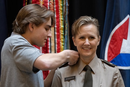 Laurence Jennings pins one-star rank on his mom, Brig. Gen. Paige M. Jennings, U.S. Army Financial Management Command commanding general, during her promotion ceremony at the Indiana Statehouse in Indianapolis Feb. 17, 2023. Jennings, a native of Missoula, Montana, began her military career in 1995 after commissioning into the Finance Corps as a distinguished military graduate of the University of Montana’s Grizzly Battalion Army Reserve Officer Training Corps program. (U.S. Army photo by Mark R. W. Orders-Woempner)