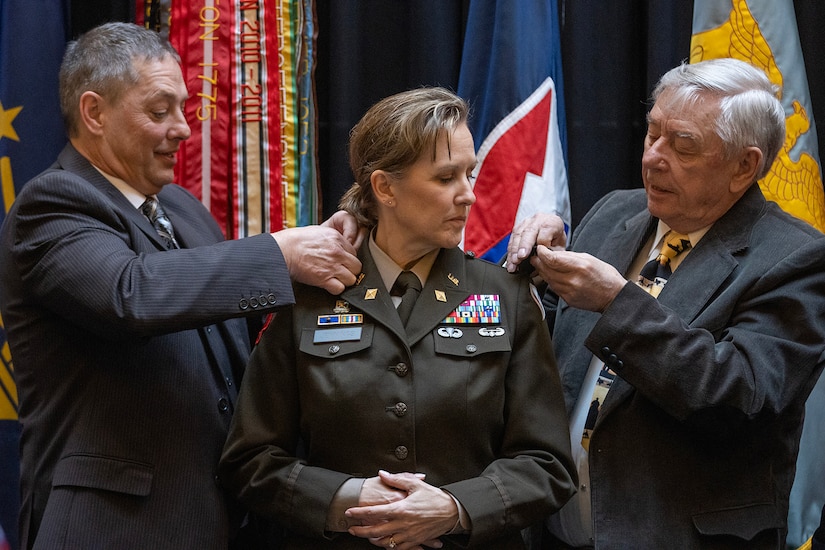 Larry Jennings, left, and Alan Stohle, right, pin one-star rank on Brig. Gen. Paige M. Jennings, U.S. Army Financial Management Command commanding general, during her promotion ceremony at the Indiana Statehouse in Indianapolis Feb. 17, 2023. Jennings, a native of Missoula, Montana, began her military career in 1995 after commissioning into the Finance Corps as a distinguished military graduate of the University of Montana’s Grizzly Battalion Army Reserve Officer Training Corps program. (U.S. Army photo by Mark R. W. Orders-Woempner)