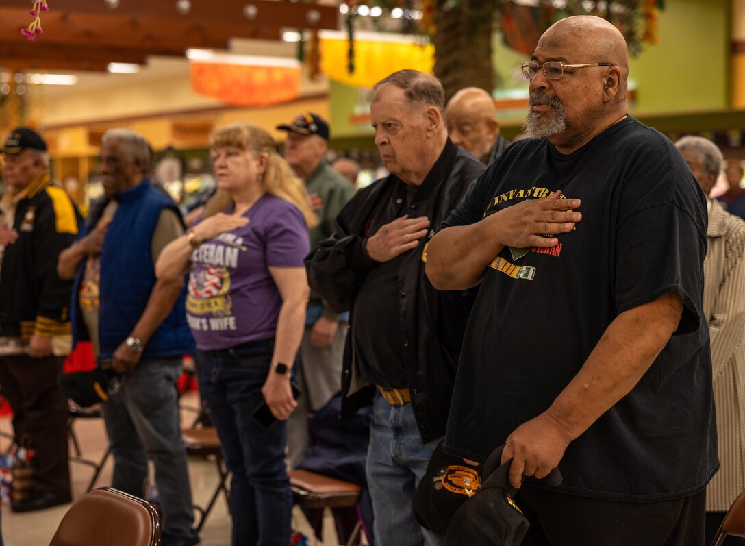 Vietnam War veterans place their hands over their hearts during the national anthem during the National Vietnam War Veterans Day commemoration ceremony at Marine Corps Base Quantico, Virginia, March 29, 2023. In 2017, President Donald Trump declared National Vietnam War Veterans Day because on this day in 1973, U.S. combat troops departed the Republic of Vietnam. (U.S. Marine Corps photo by Lance Cpl. Joaquin Dela Torre)