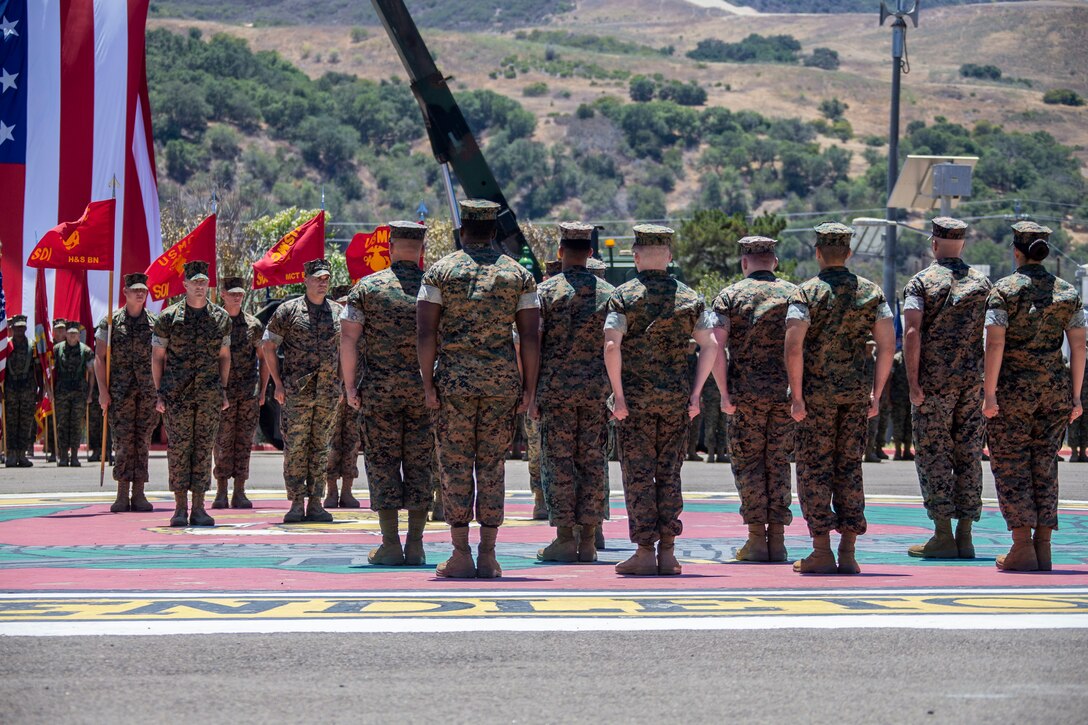 U.S. Marines with the School of Infantry - West, stand at attention during a change of command ceremony at SOI-West on Marine Corps Base Camp Pendleton, California, June 24, 2022. During the ceremony, Col. Coby Moran relinquished command of SOI-West to Col. Seth MacCutcheon. (U.S. Marine Corps photo by Cpl. Alison Dostie)