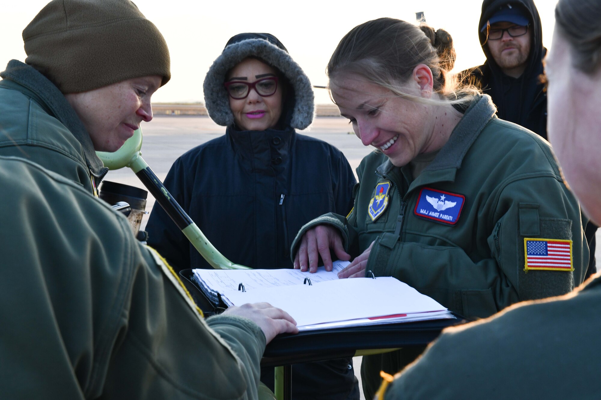 U.S. Air Force Lt. Col. Sarah Bulinski (left), 54th Air Refueling Squadron (ARS) commander, and Maj. Aimee Parenti, 54th ARS instructor pilot, review maintenance forms for a KC-135 Stratotanker prior to a flight at Altus Air Force Base, Oklahoma, March 28, 2023. Aircrew members perform pre-flight checks to ensure the aircraft is ready for deployment. (U.S. Air Force photo by Airman 1st Class Miyah Gray)