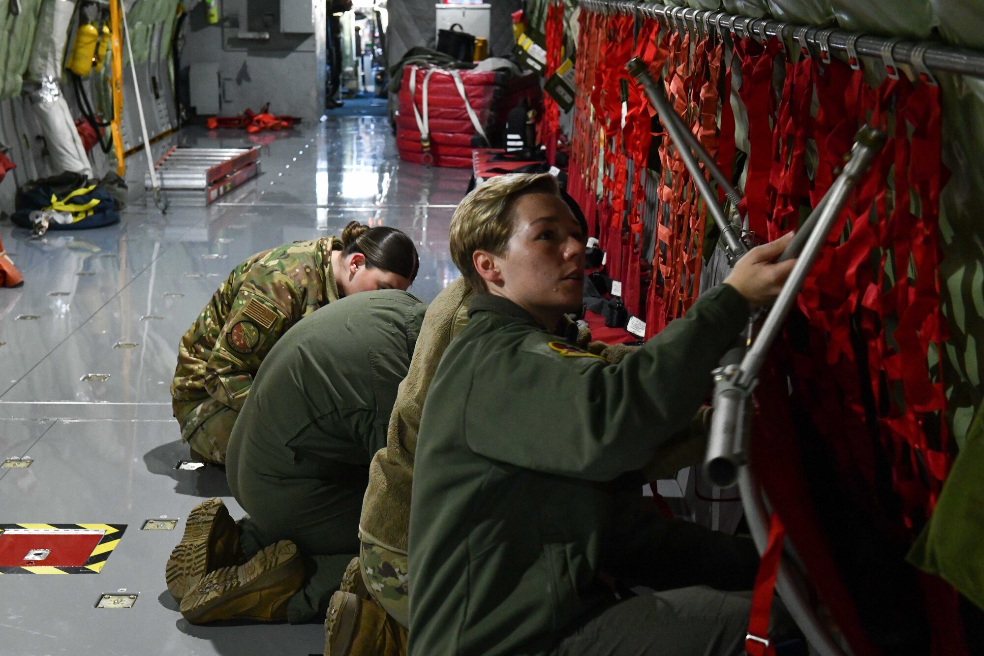 Airmen from the 54th Air Refueling Squadron set up seating on a KC-135 Stratotanker prior to a flight at Altus Air Force Base, Oklahoma, March 28, 2023. The KC-135 is capable of aerial refueling and transport of passengers and cargo. (U.S. Air force photo by Airman 1st Class Miyah Gray)