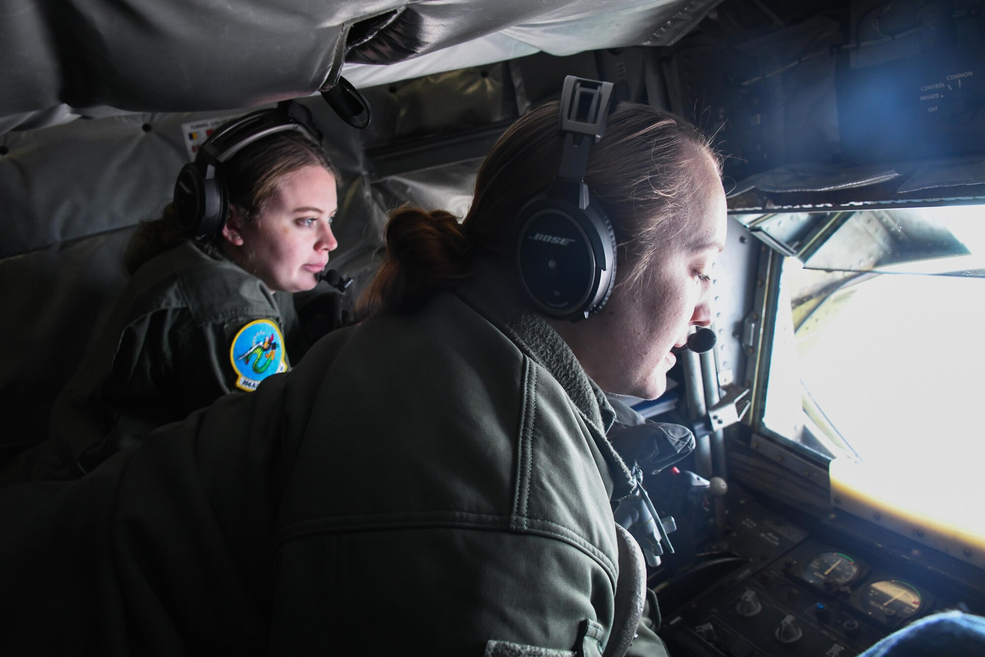 U.S. Air Force Tech. Sgt. Samantha Grendahl (right), 54th Air Refueling Squadron (ARS) instructor boom operator, and Airman 1st Class Maddie Veyon,166th ARS boom operator in training, position the boom of a KC-135 Stratotanker at Altus Air Force Base, Oklahoma, March 28, 2023. Boom operators are responsible for transferring fuel from one aircraft to another while in flight. (U.S. Air Force photo by Airman 1st Class Miyah Gray)