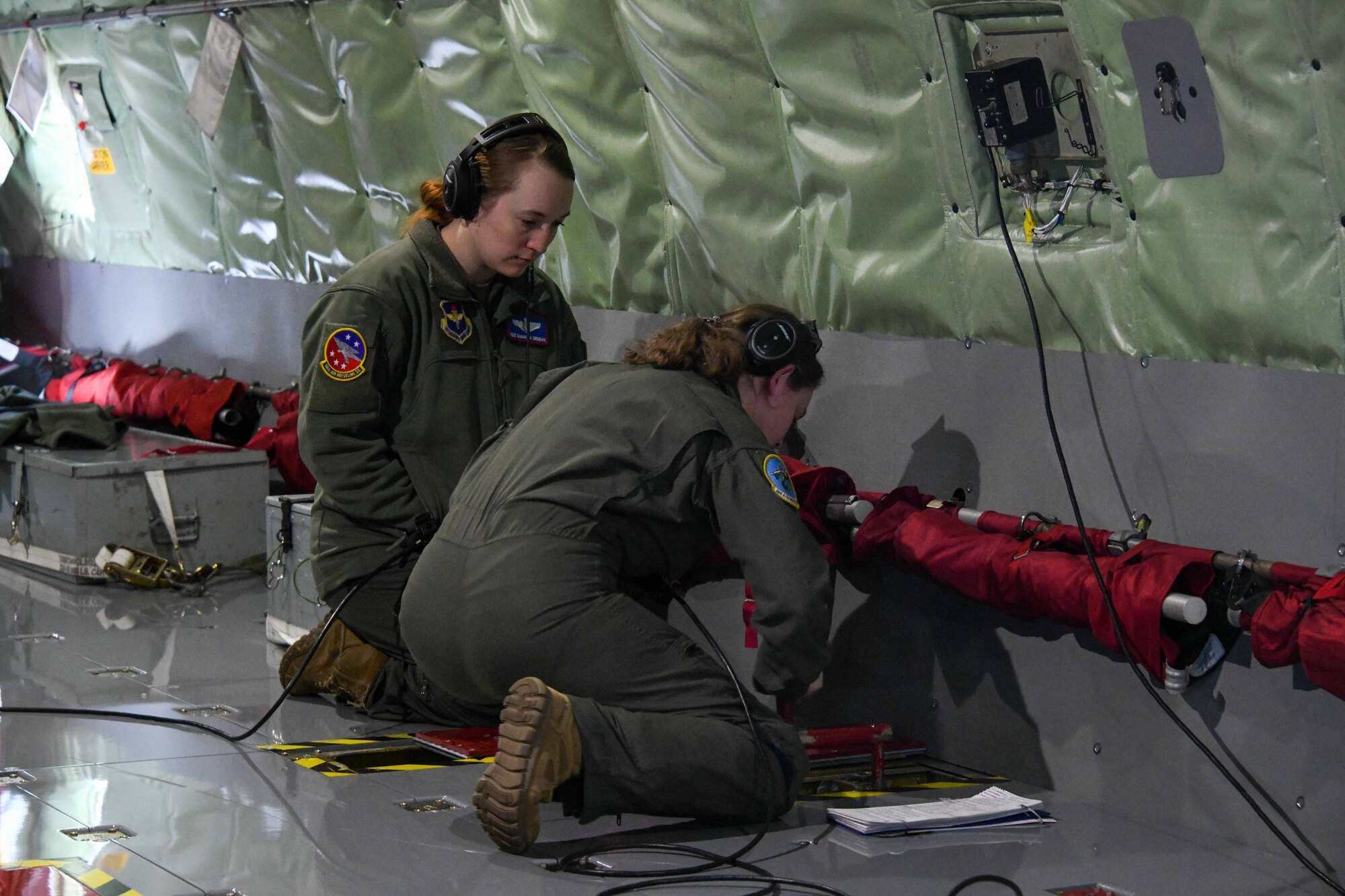 U.S. Air Force Tech. Sgt. Samantha Grendahl, 54th Air Refueling Squadron (ARS) instructor boom operator, and Airman 1st Class Maddie Veyon, 166th ARS boom operator in training, manually operate the hydraulics of a KC-135 Stratotanker at Altus Air Force Base, Oklahoma, March 28, 2023. Students practice operating hydraulics manually in case systems fail during operations. (U.S. Air Force photo by Airman 1st Class Miyah Gray)